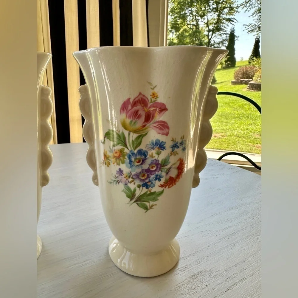 1950’S SET/2 , FLORAL VASES. SOFT CREAM COLOR WITH ONE SIDED FLORAL DESIGN.